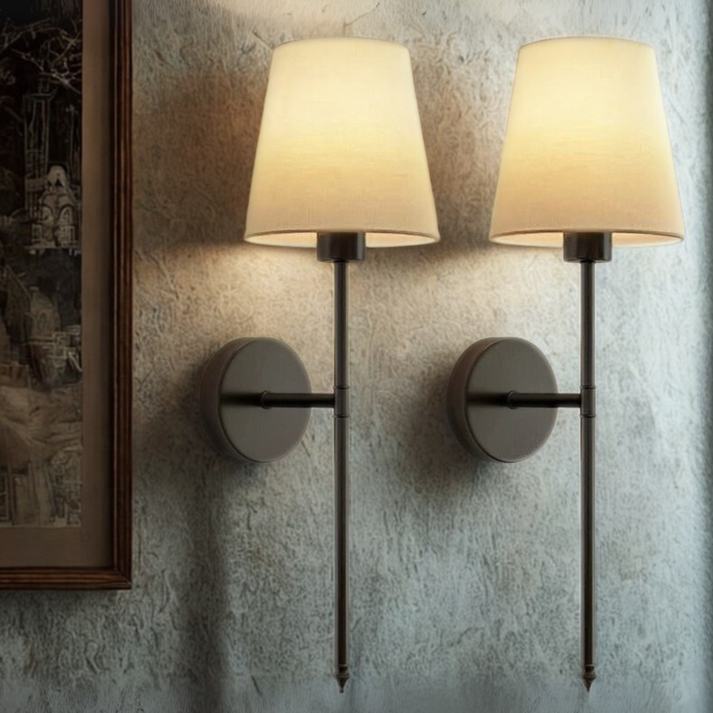 Pair of wall-mounted lamps with beige shades on a textured wall.
